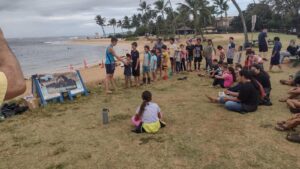 Group of children standing in line at beach